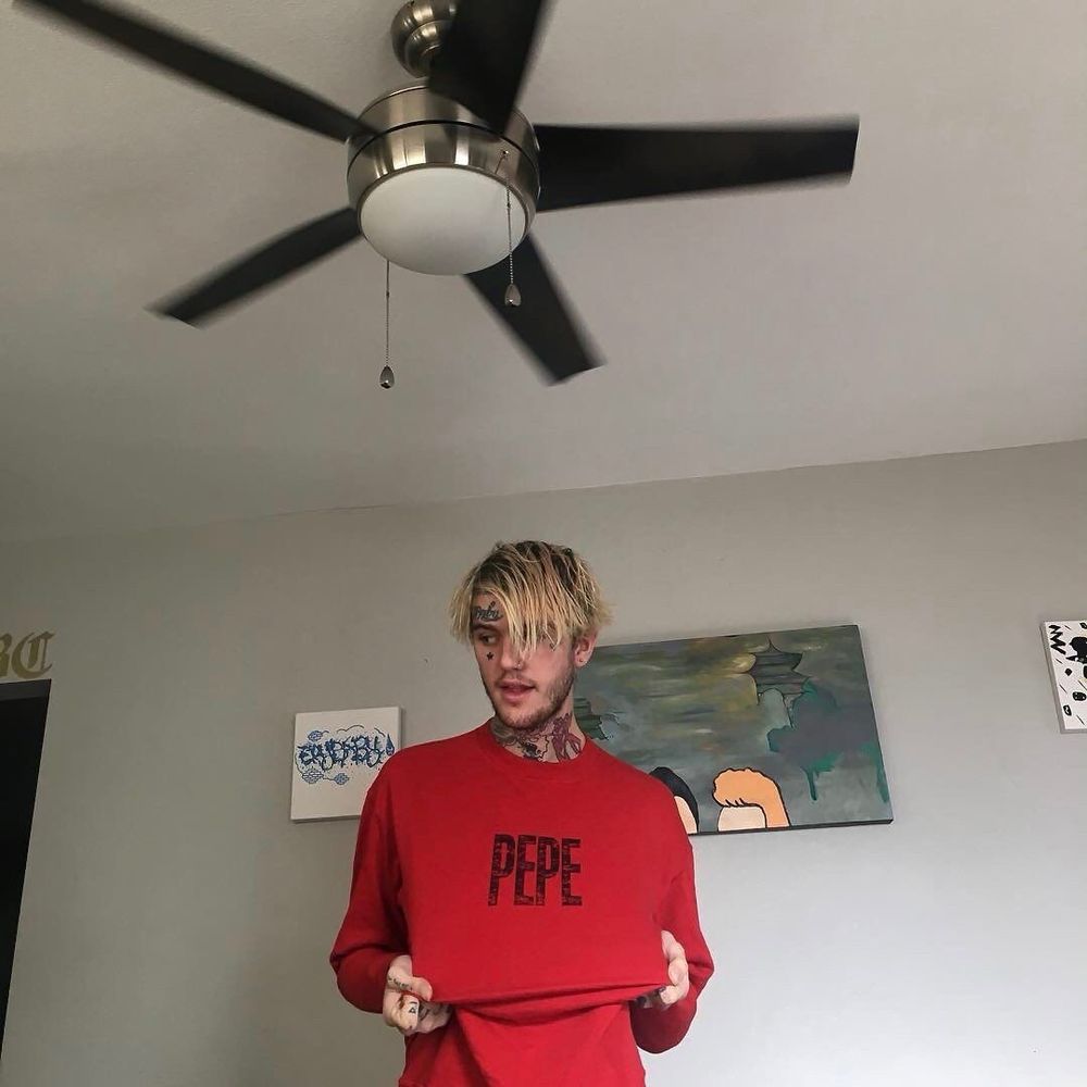 lil peep in a red shirt that says "pepe"