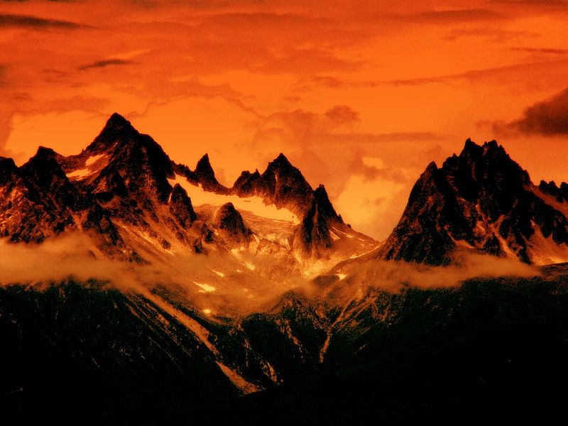 A photo of a mountain range and sky, with the colour red greatly enhanced to make the scene appear as if taken in the Middle Earth realm of Mordor.