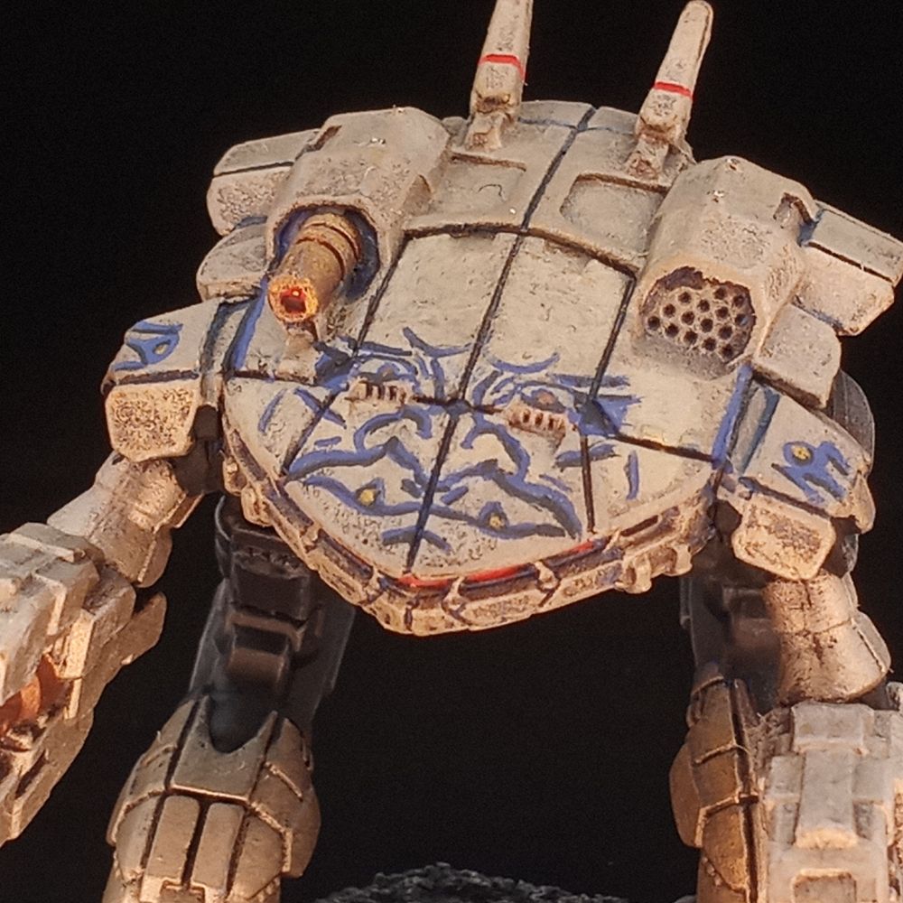 A gold King Crab with a blue Oni face painted across the upper carapace.