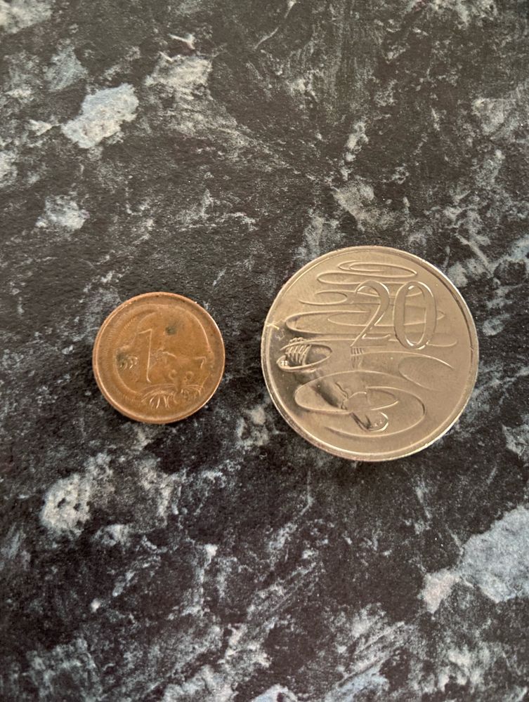 (Left) A small bronze 1 cent Australian coin, dated back to 1972.
(Right) A 20 cent silver Australian Coin
