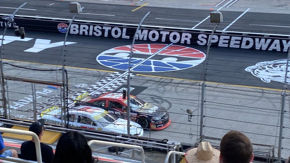 Thomas Annuziata’s white #70 and Tyler Reif’s black and red #23 ARCA cars thunder across the start finish line in a side by side battle for position.