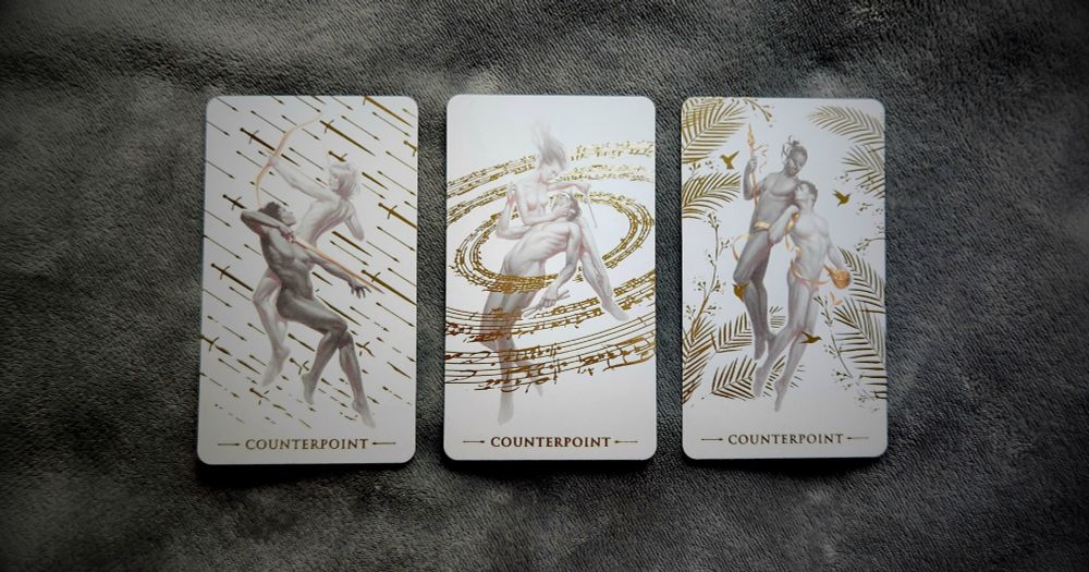A photo of three Counterpoint cards from Arthur Wang's Ephemere tarot deck. They are arranged side-by-side on a gray fleece blanket.