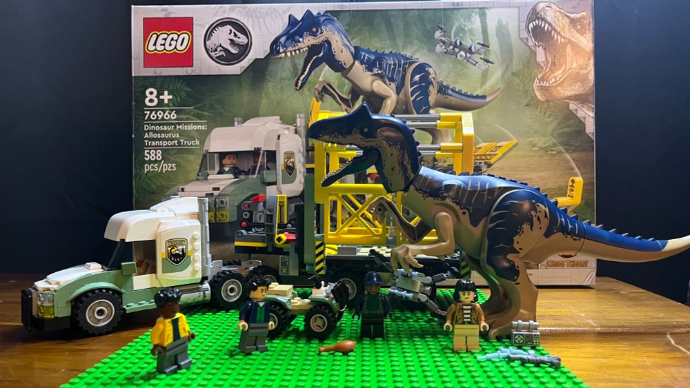 Lego set from the Jurassic World line featuring a truck and an Allosaurus with 4 human characters