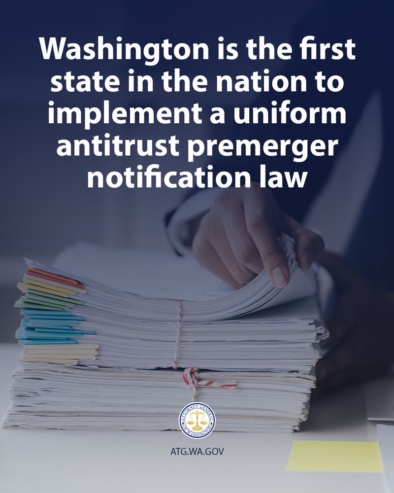 A large stack of paper files and documents sits on a desk. A hand reaches into the stack, pulling out a document. Text overlaying the image reads: "Washington is the first state in the nation to implement a uniform antitrust premerger notification law." At the bottom of the image, the seal of the Attorney General of Washington is visible, along with the website ATG.WA.GOV. There is a yellow sticky note on the desk to the right.
