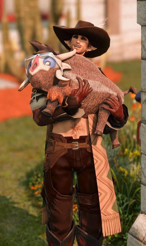 Kiv is wearing a leather western outfit and holding a rroneek calf, who is wearing a fashionable pair of shades.