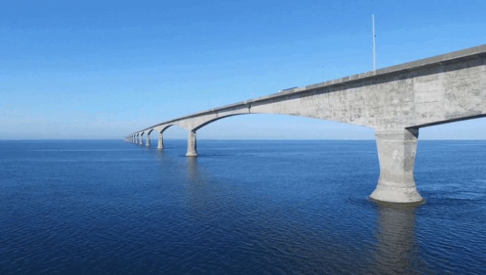 a bridge over a body of water with a blue sky behind it