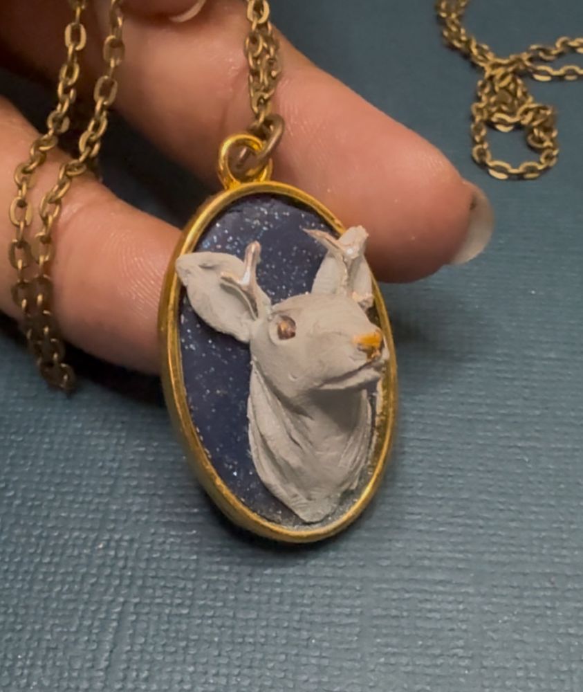 Silver stag pendant sculpted with clay in a gold bezel with gold chain 