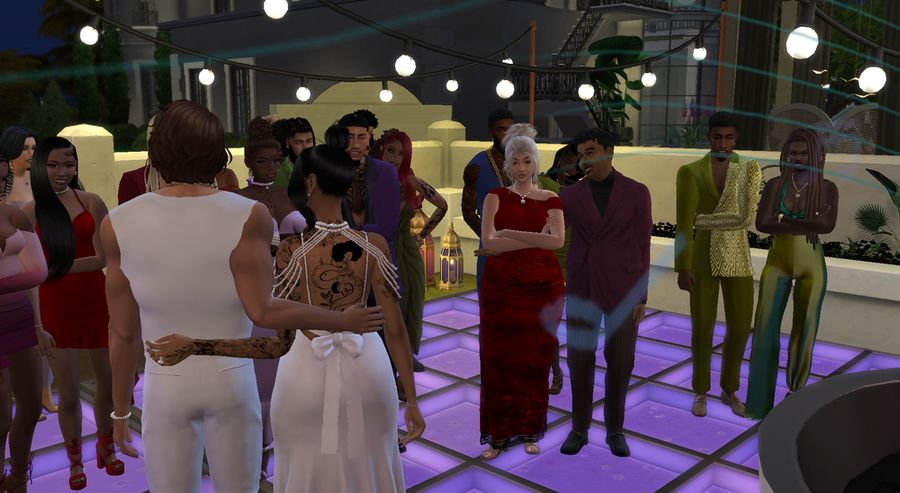 indya and orange are standing on the dance floor speaking to their guests. in the crowd are her parents, his parents, best friends, the michaelson-harrises, and other celeb guests.