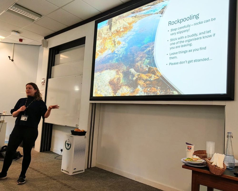 Me presenting the rockpooling activity at the front of a seminar room.