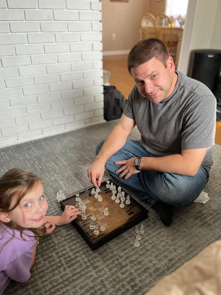 Myself and my daughter on the living room fooor playing chess 
