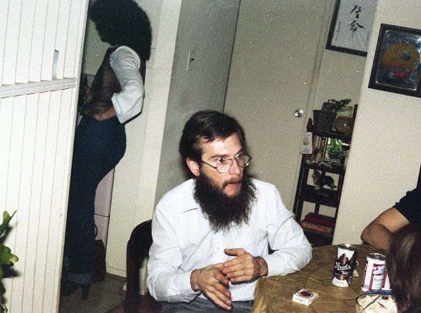 bearded man sitting at a table