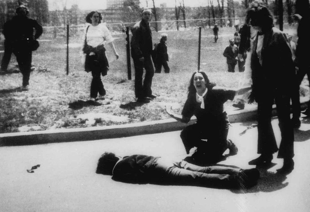 witness weeps over one of four corpses at kent state, where US troops rioted in response to peaceful protest