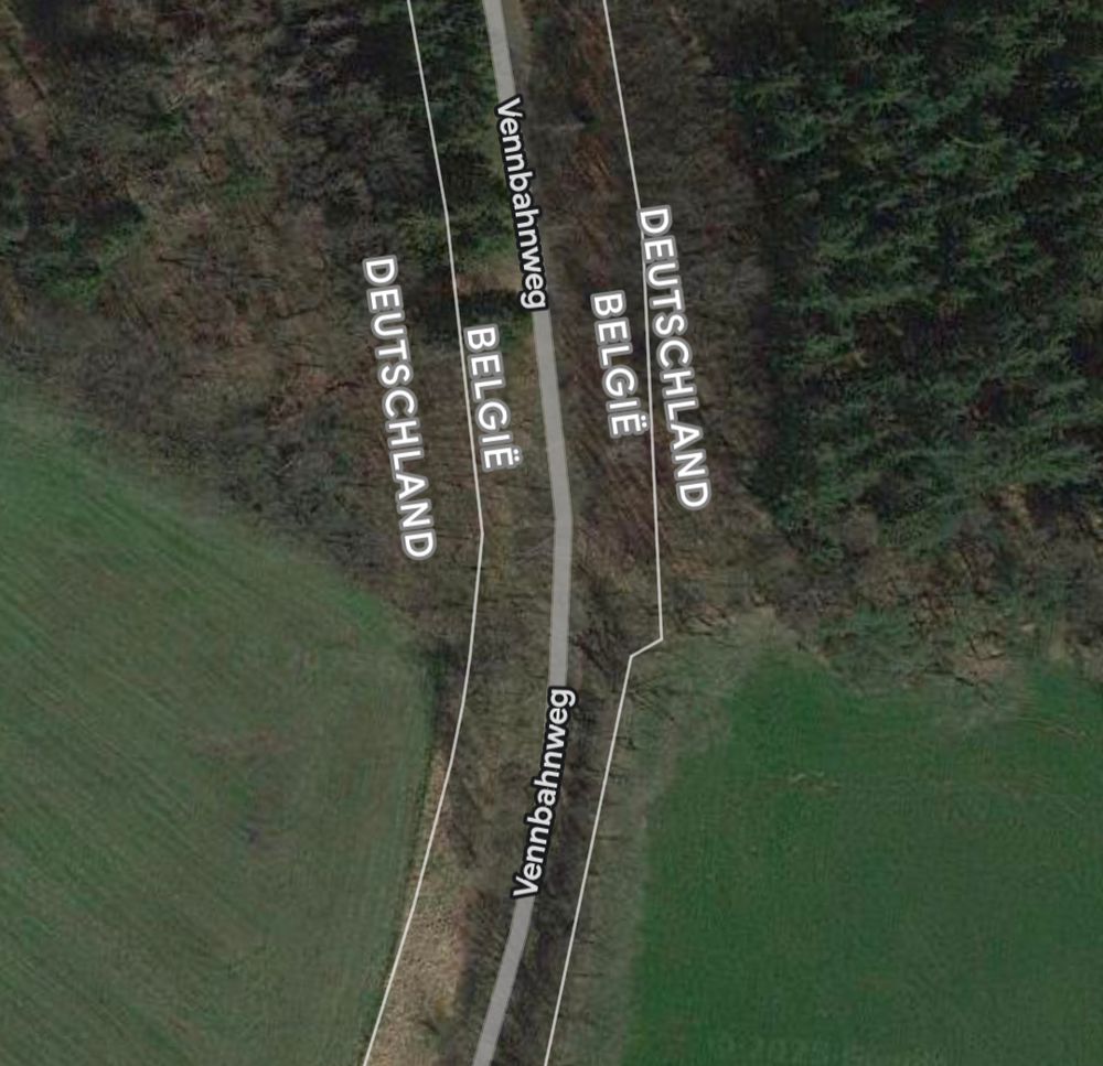 Screenshot from Google Maps showing a narrow sliver of Belgian territory bordered by two (separated) pieces of German land, just broad enough for a (former) railway track. The former railway line, the Vennbahn, has been turned into a cycle path.