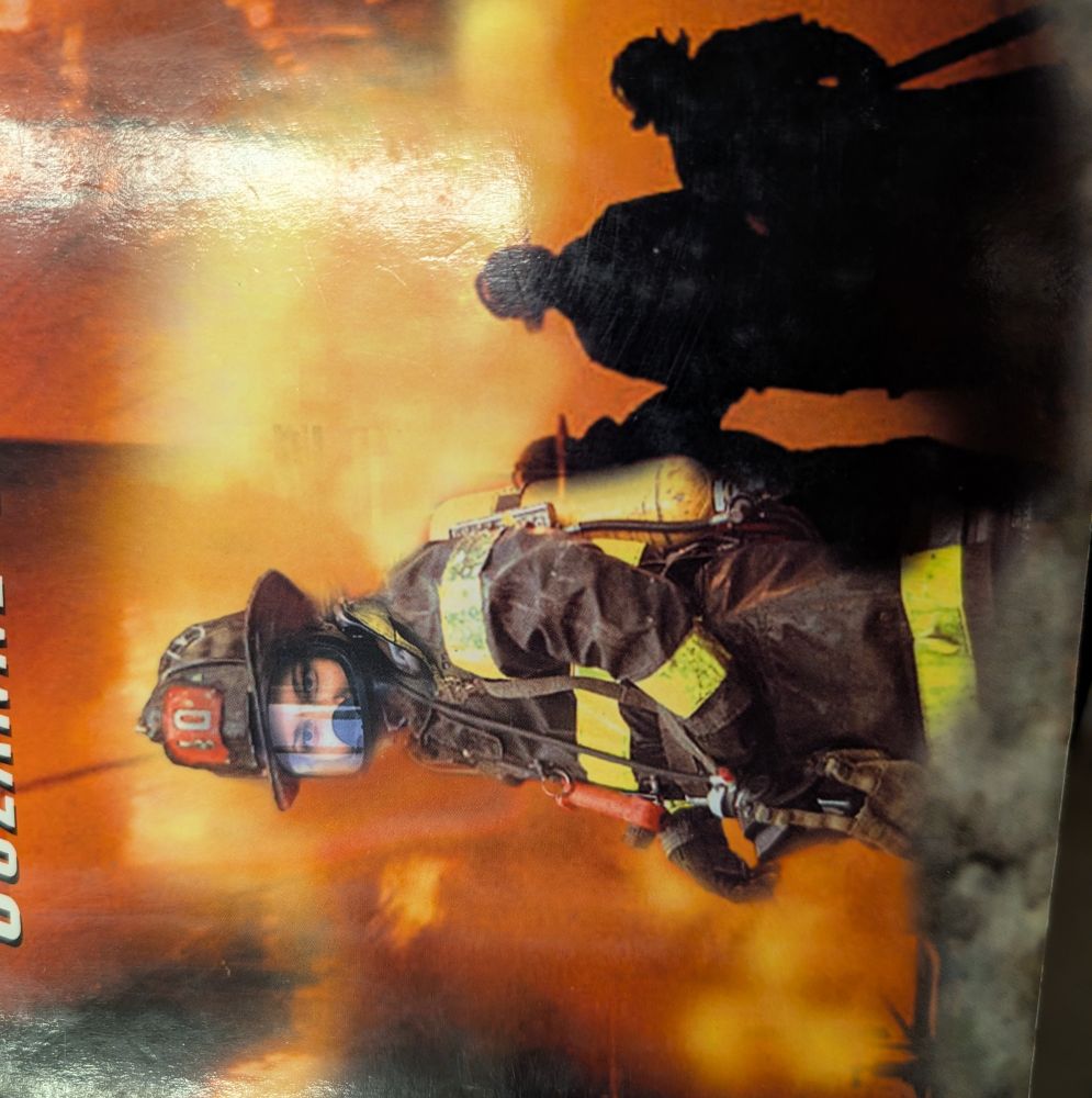 A book cover showing a fire and a few firefighters, the foremost is as described in the post.