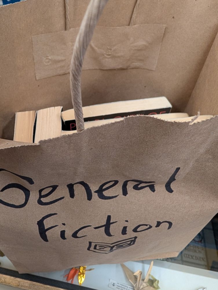 A paper bag with some books and General Fiction written on it