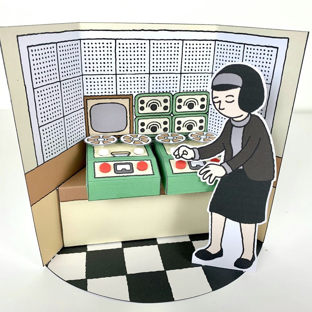 a paper model of Delia Derbyshire attending to some tape machines