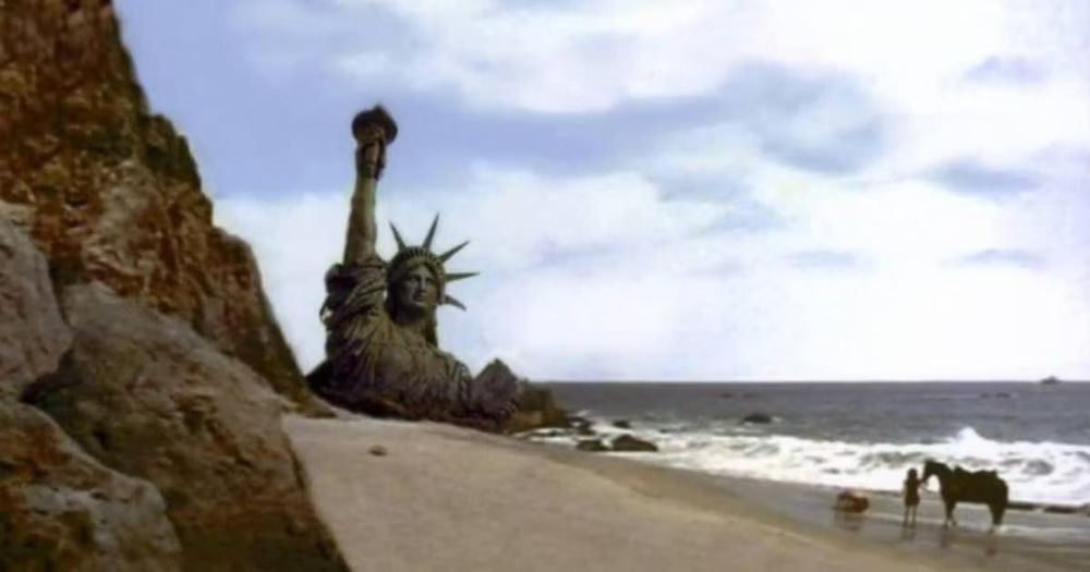 A person with a horse approaching a half-buried Statue of Liberty on the beach.