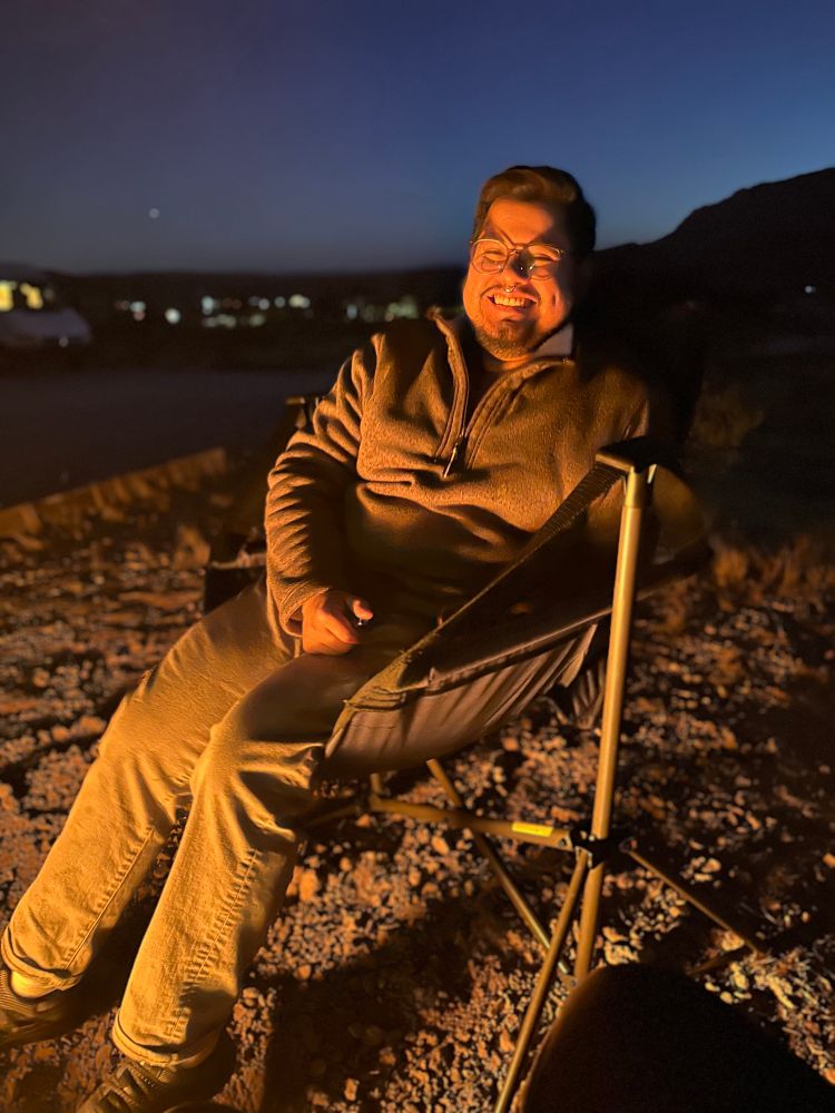 Mikey sitting in chair again, this time big cheesing 