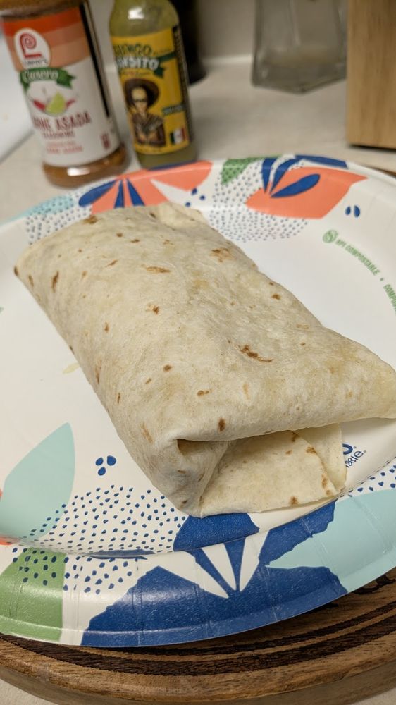 a double wrapped burrito using rice, seasoning, green habanero sauce, and a (cooked) frozen bean and cheese burrito. wrapped.