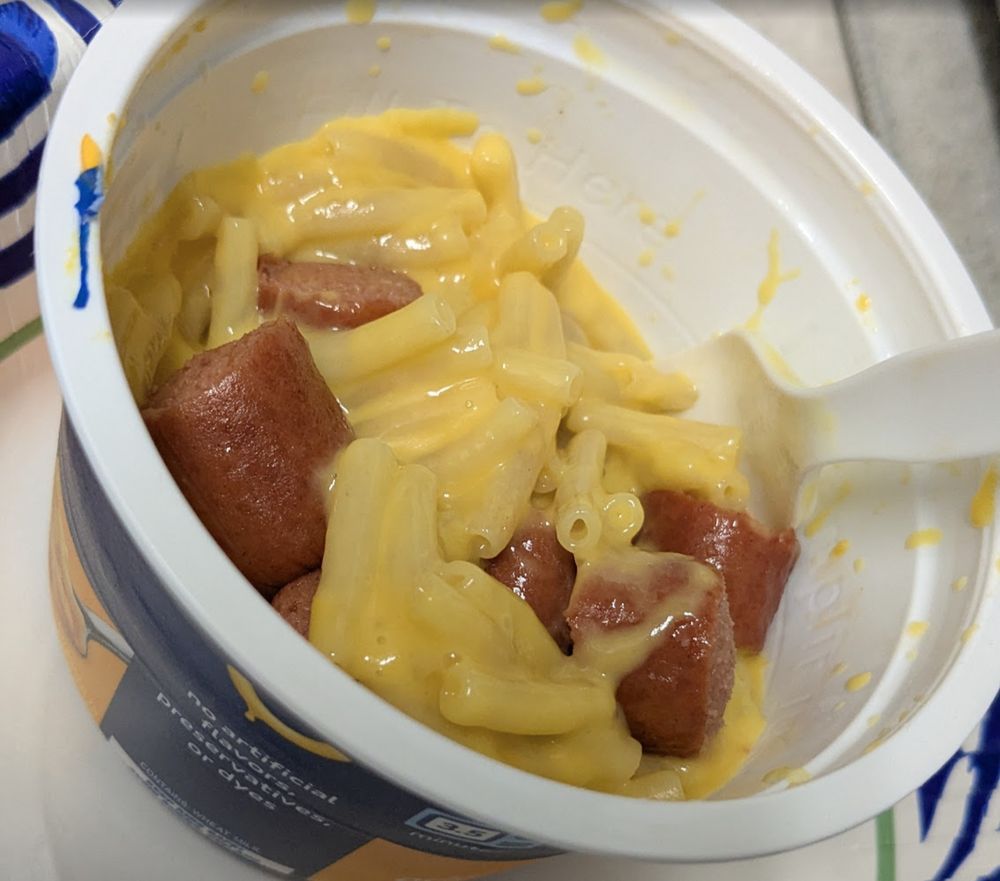 easy mac and cheese with a beef hotdog cut up into it