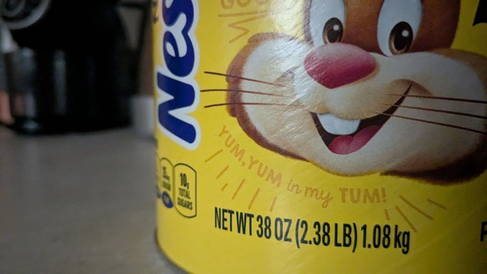 intense close-up of a 1kg Nestle Quik chocolate powder container