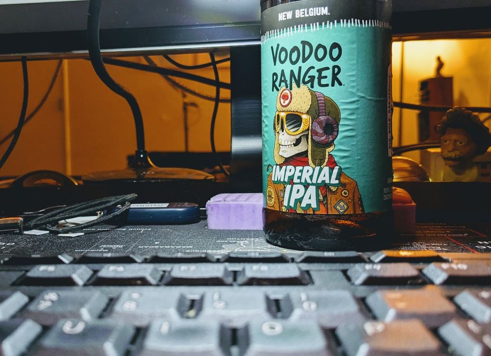 a Voodoo Ranger Imperial IPA beer along side other desk knick-knacks