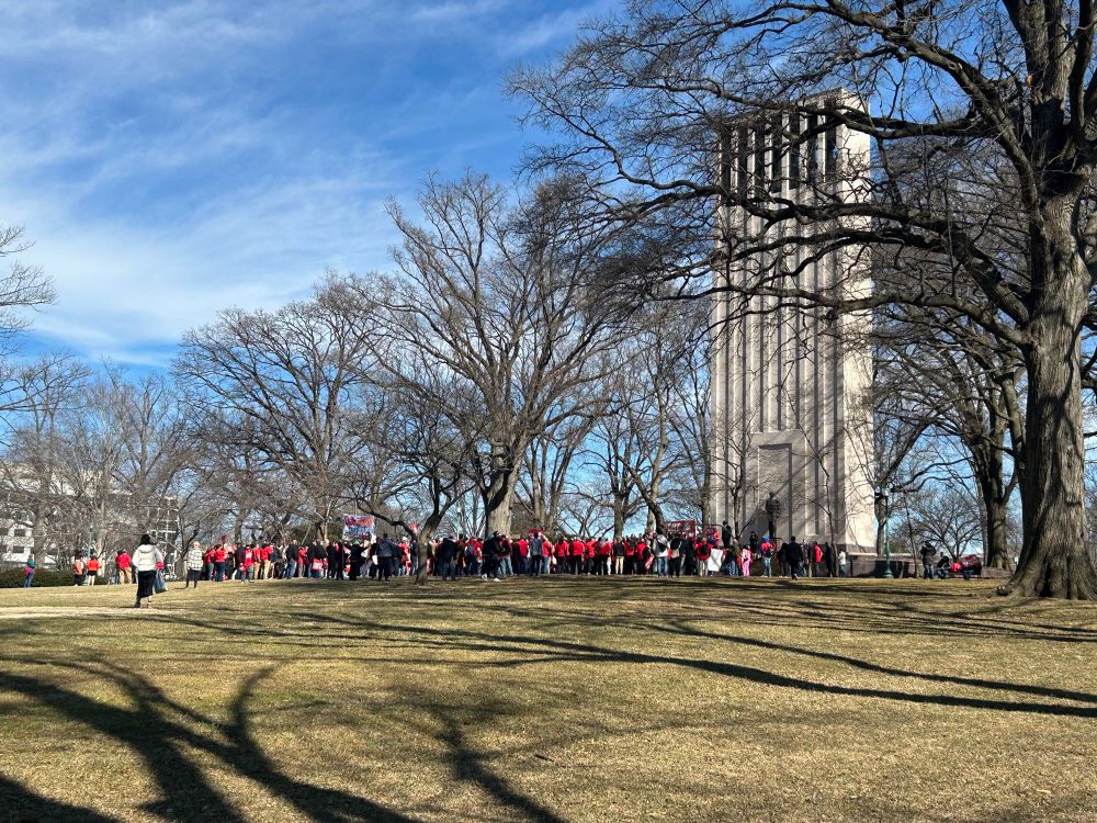 Long distance photo of a crowd protesting at the Taft Memorial Carillon. 
