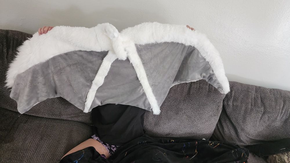 Photo of one wing in progress, currently hand sewing the fur in the webbing area so it can be stuffed. 