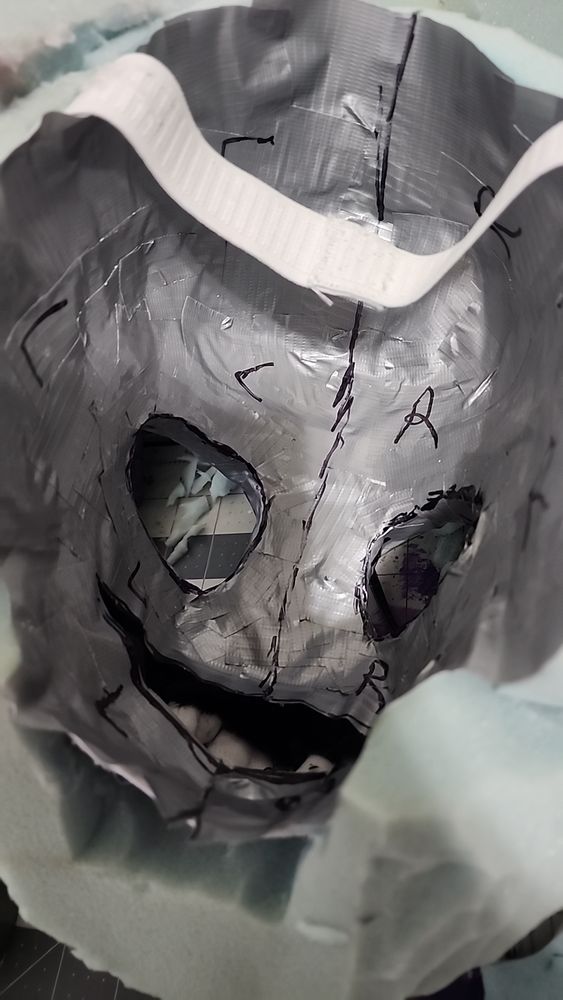 Picture of the inside of Kebrii's fursuit head covered in duct tape for the lining process