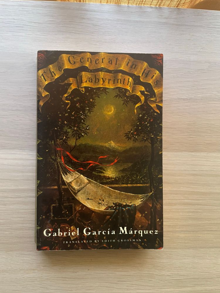 The General in His Labyrinth by Gabriel Garcia Marquez rests on a wooden surface.