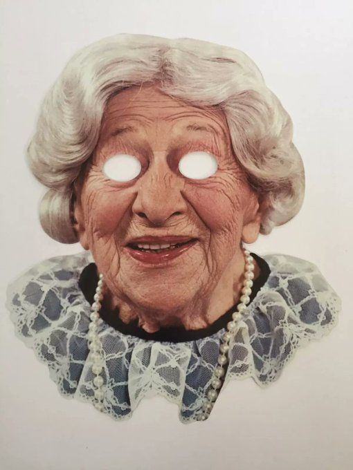 A photorealistic mask of Clara Peller, the woman who shouted "Where's the Beef?" in old Wendy's commercials. The mask features her wavy grey hair and a string of pearls. The eyes are cut out, giving an incredibly unsettling appearance