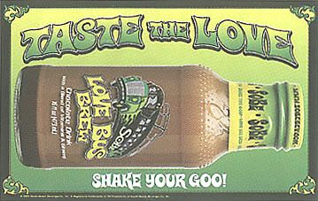 The words "Taste the Love" are written in a psychedelic font, above a sideways glass bottle filled with brown liquid. At the bottom of the bottle is a concentration of dark brown "good". The bottle features the words "Love Bus Brew" and a bus with flames on it. At the bottom, the ads states "Shake Your Goo!"