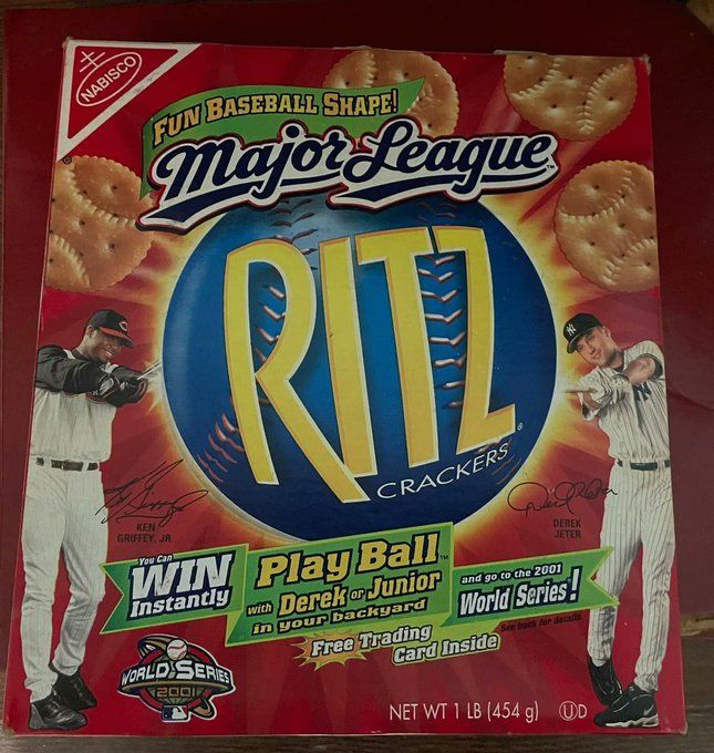 A red Ritz Cracker box with pictures of Ken Griffey, Jr. and Derek Jeter swinging bats, in front of the Ritz logo and Ritz crackers, which have stiches to look like baseballs