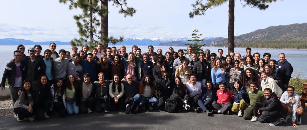 Group picture of people in the Stanford NLP Group gathered in front of the shores of Lake Tahoe.