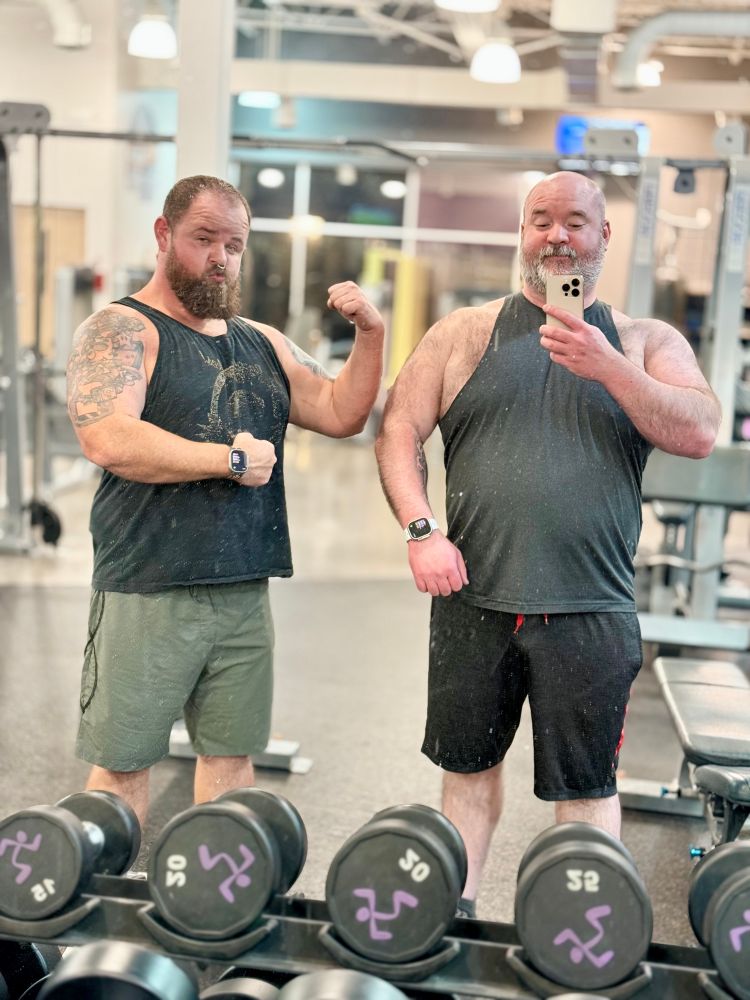 Two meatballs flexing and making silly faces in a gym mirror 