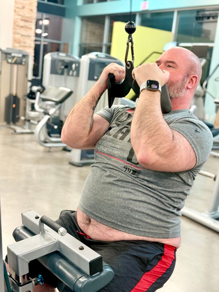 Big dad does another bicep pull down exercise with his belly out 