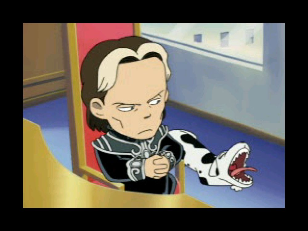 Oberstein looking over at his dog while he sits at his desk.
