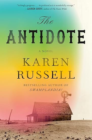 A ramshackle old farmhouse with a windmill on top. It sits amid a dusty, dry, wasteland, with a fence post just visible behind it. The background moves through a spectrum from light pink through darker pink through yellow through green ending at the top with a teal color. The title, "the Antidote" is centered in the top third. Below reads "A novel" and then in large size font Karen Russel. Then in smaller font, "BESTSELLING AUTHOR OF SWAMPLANDIA!"