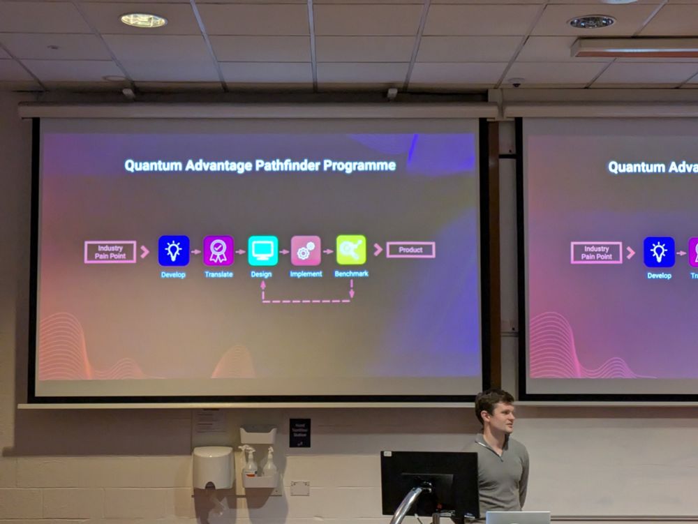 man standing below a big display showing a workflow diagram