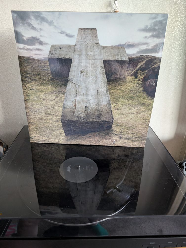 Gatefold of the Justice record "Audio, Video, Disco" on top of a record player. 