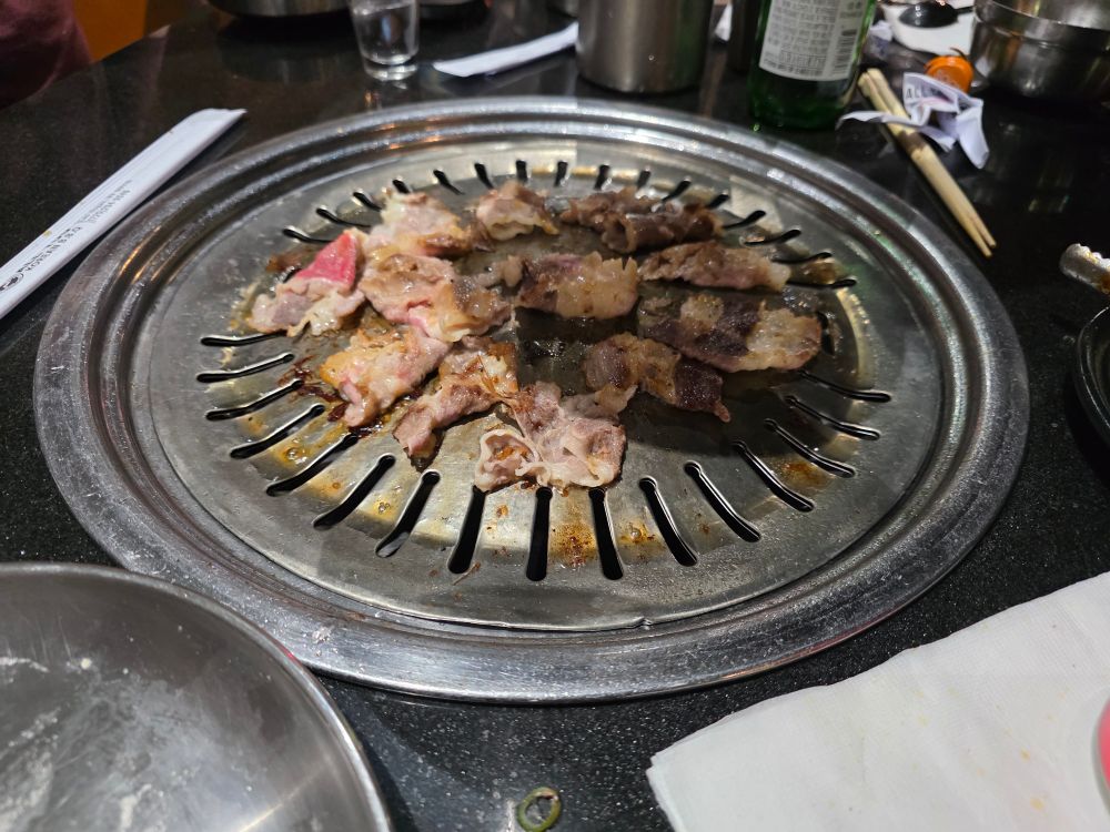 KBBQ with thinly cut brisket on the grill