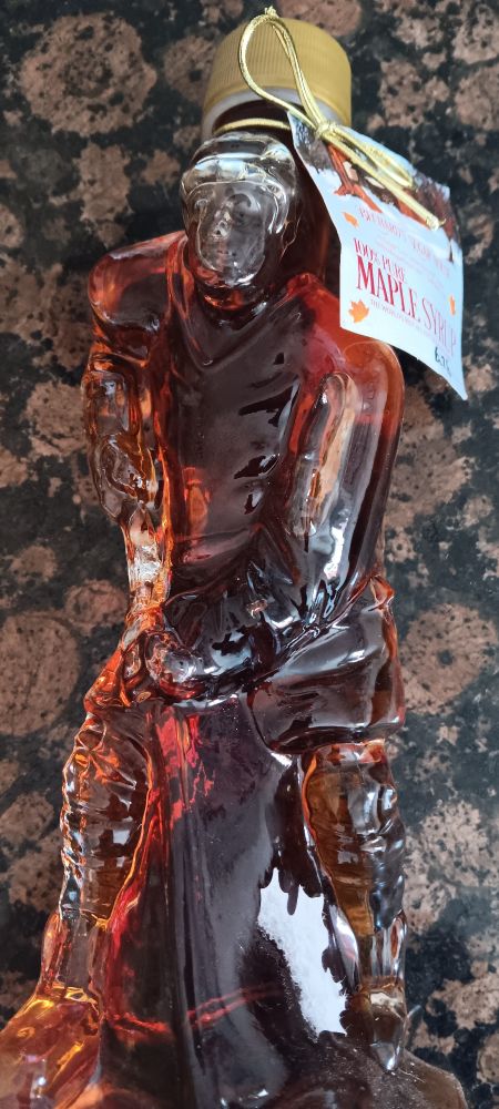 Maple syrup in a glass, hockey player shaped bottle.