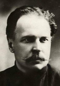 Portrait von Rogdajeff, er hat eine hohe Stirn und trägt einen gezwirbelten Schnauzbart.