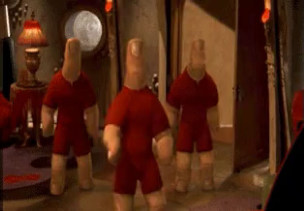 a couple of stuffed dolls in red shirts are standing in a room