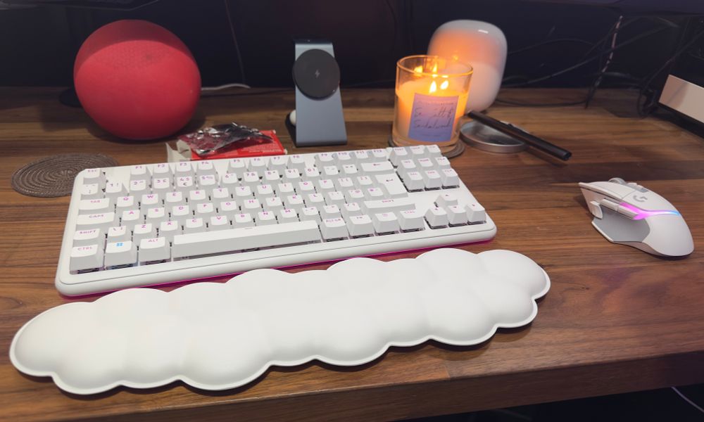 Kit’s new keyboard and mouse; a wireless white Logitech pair. Also in the picture is a wrist rest that looks like a cloud as well as an Amazon Echo, a candle and a pack of vocalzone tablets.