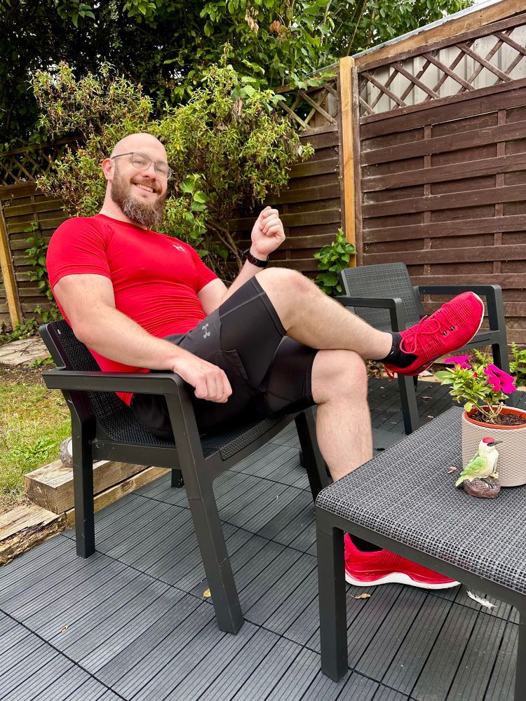 Kit sits on a chair in the garden.