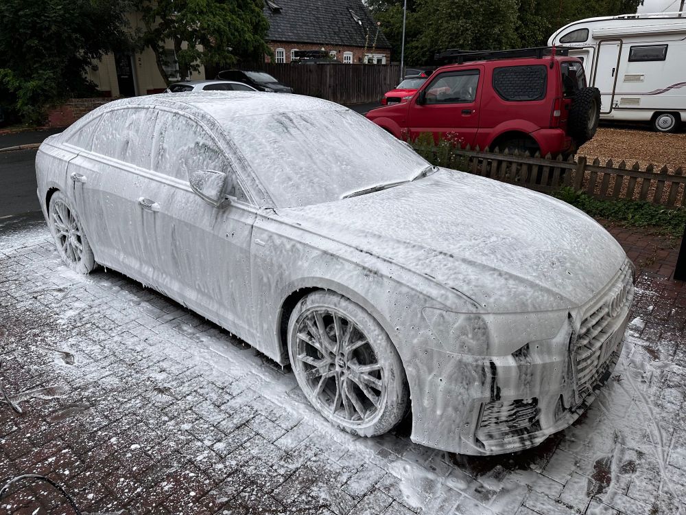 Kit’s car is covered in snow foam. 