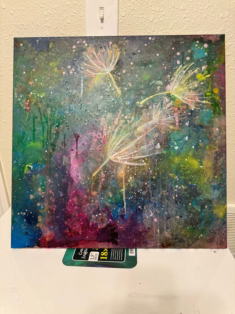 Colorful  galaxy like background with four dandelion fluffs flouting in foreground. Paint splashes throughout pieces. Mixed media on canvas