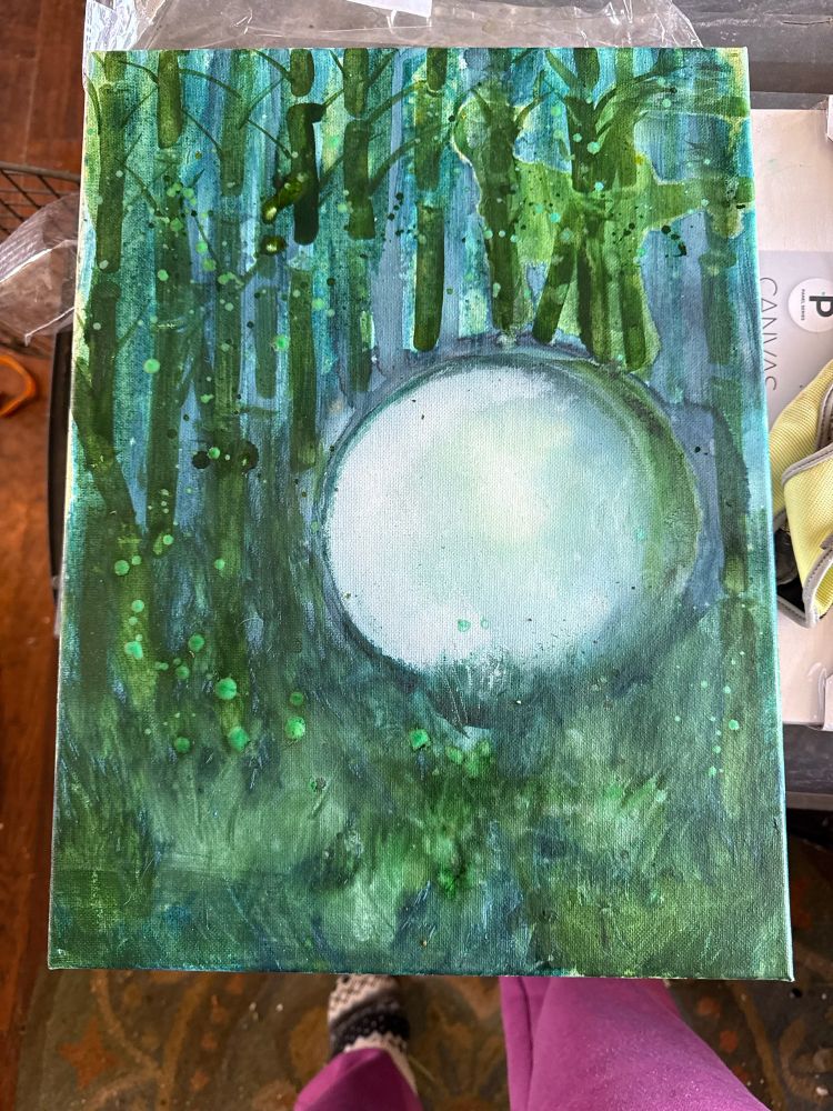 A bubble with a background of different green abstract bamboo like trees and grass. Monotone