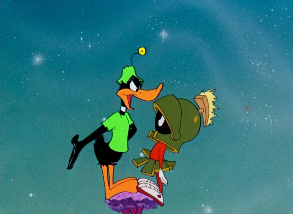 Daffy Duck and Marvin the Martian standing face-to-face on a tiny shattered remnant of a planet yelling at each other....